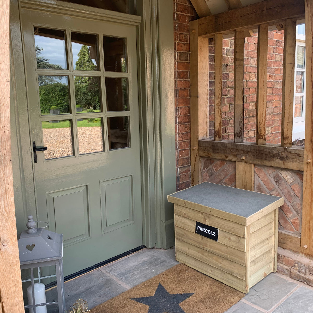 Natural DelSafe wooden parcel delivery box beside a front door