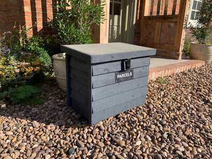 Dark Grey DelSafe wooden parcel delivery box with grey felt roof in a garden setting